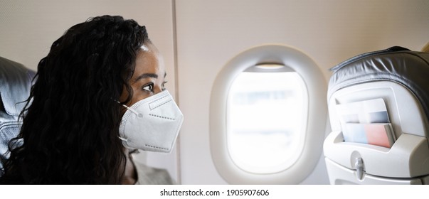 African Woman In Face Mask On Air Plane