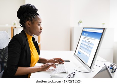 African Woman Filling Survey Poll Or Form On Desktop Computer