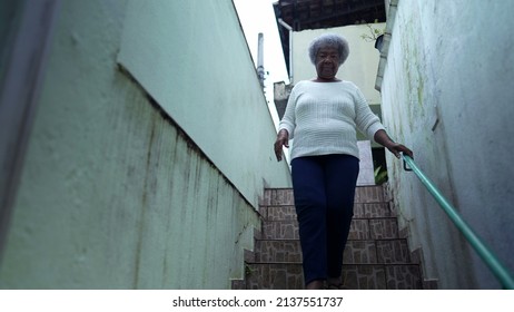 An African Woman Going Down The Stairs Opening Home Gate And Leaving House To Urban Sidewalk Street