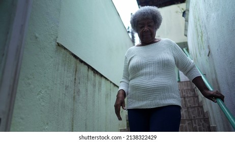 An African Woman Going Down The Stairs Opening Home Gate And Leaving House To Urban Sidewalk Street