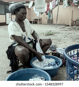 African Woman Hand Washing Her Clothes In Accra Ghana.