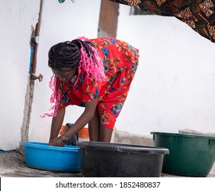 African Woman Hand Washing Laundry Outdoors