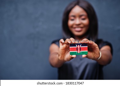 African Woman Hold Small Kenya Flag In Hands.