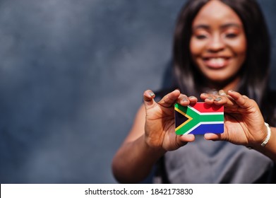 African woman hold small South Africa flag in hands. - Shutterstock ID 1842173830