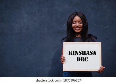 African Woman Hold White Board With Kinshasa DRC Inscription. Most Populous City In Africa Concept.