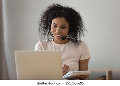 African Woman Interpreter In Headset Working From Home Online Translation Job, Girl Improve Foreign Language Skills Look At Pc Learns Repeat Words Memorizes Them, Do Task Use Internet Website Concept