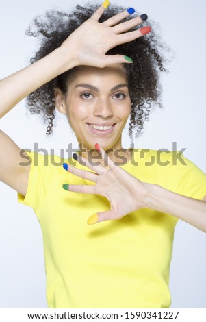 African woman with paint on fingertips