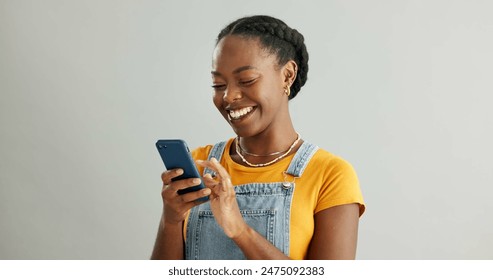 African woman, phone and texting in studio with smile, reading or thinking for contact by white background. Gen z person, girl and happy with smartphone for chat, meme or social network on mobile app - Powered by Shutterstock