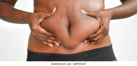 African Woman Pinching Fat Tummy