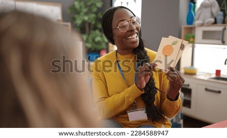 African woman preschool teacher on a vocabulary lesson at kindergarten