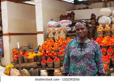 African Woman Selling Fresh Fruits And Vegetables At The Farmers Market