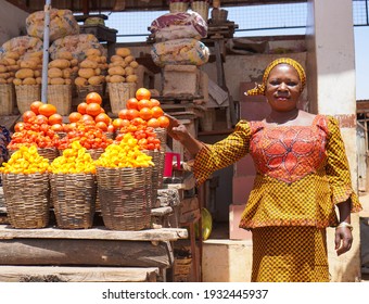 African Woman Selling Fresh Fruits And Vegetables In The Market