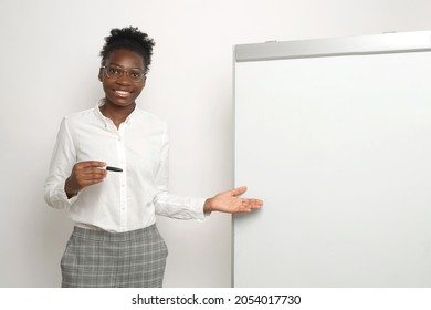 african woman showing white board in office 