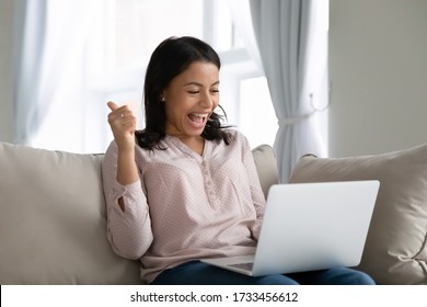 African woman sit on sofa hold notebook on lap feels happy showing thumbs up check bank application form loan approved, got new job, successfully pass entry exams, tax refund, 5g fast internet concept