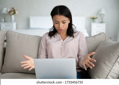 African Woman Sit On Sofa Put Notebook On Lap Has Problems With Device Looks At Screen Feels Annoyed By Unexpected Pc Shut Down Unsaved Documents Turn Off Without Warning, Need Repair Service Concept