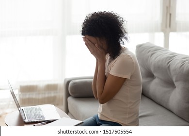 African Woman Sitting Near Computer Cover Face With Hands, Cyberbullying Bullying Through Device, Humiliation Public Shaming On Social Media, Employee Fired From Remote Work Crying Feels Awful Concept