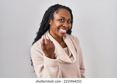 African Woman Standing Over White Background Beckoning Come Here Gesture With Hand Inviting Welcoming Happy And Smiling 