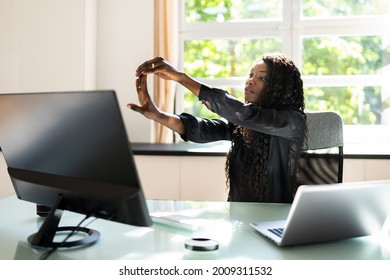 African Woman Stretching Exercise At Desk Working On Computer
