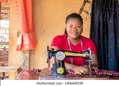 African Woman Tailor Smiling While Working