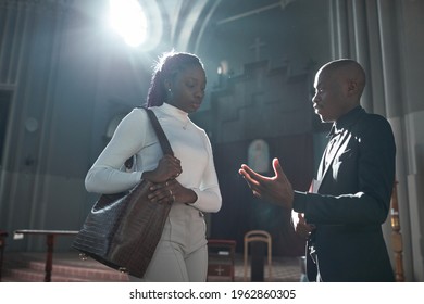 African Woman Talking To Priest After Ceremony In The Church