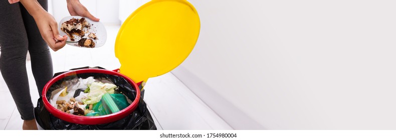 African Woman Throwing Trash In Kitchen Garbage Bin