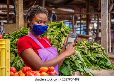 African Woman Trader Swiping A Credit Card On A Point Of Sale Device