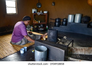  African woman traditional cooking and  sitting besides cooking pot in Harare Zimbabwe on 2017-06-12 