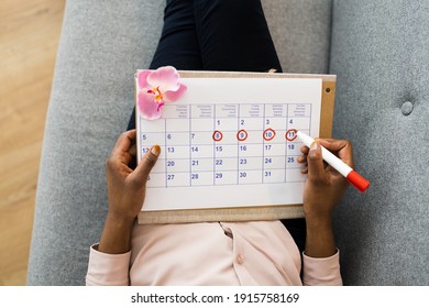 African Woman Using Menstrual Cycle Or Period Calendar