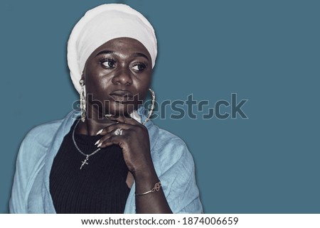 African woman in white headdress thinking about her future