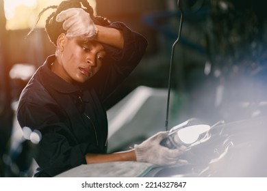 african woman worker hard working tired sweat for mechanic girl engine check garage 