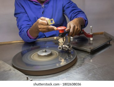 African woman working on a diamond at the polishing wheel, in a factory in Botswana - Shutterstock ID 1802638036