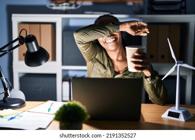 African Woman Working Using Computer Laptop At Night Smiling Cheerful Playing Peek A Boo With Hands Showing Face. Surprised And Exited 