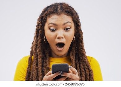 African woman, wow and cellphone in studio for surprise, emoji and contact and social media for networking. Gen z, female student and influencer with shock for technology, meme and online by backdrop