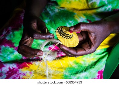 African woman's hands working weaving yellow thread on African Bahima women's clothing in Uganda, women's crafts - Shutterstock ID 608354933