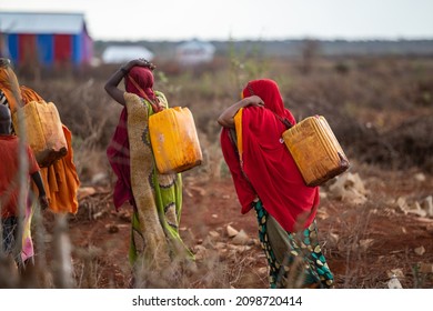 African Women Carrying Water With Yellow Drums, Baidoa Somalia - 15 May 2019