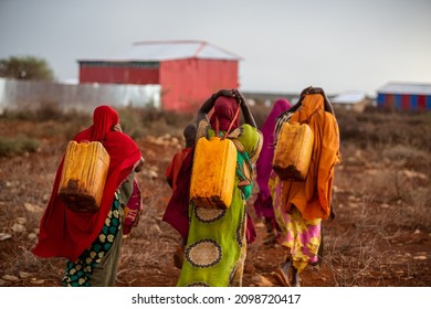 African Women Carrying Water With Yellow Drums, Baidoa Somalia - 15 May 2019