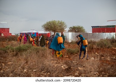 African Women Carrying Water With Yellow Drums, Baidoa Somalia - 15 May 2019