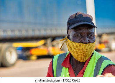 African worker  in a busy area of Gaborone city, truck passing by 