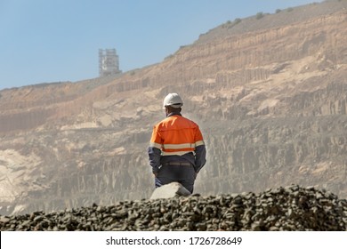 African worker in an open pit diamond mine , in Botswana