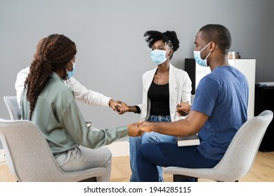 African Worship Group Holding Hands In Face Masks
