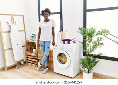 African Young Woman Doing Laundry At Home Thinking Attitude And Sober Expression Looking Self Confident 