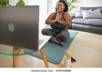 African Young Woman Doing Yoga Virtual Fitness Class With Laptop At Home - E-learning And People Wellness Lifestyle Concept