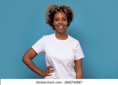 African Young Woman With Shaggy Hairstyle Smiling Cheerfully, Feeling Happy And Carefree. Studio Shot.