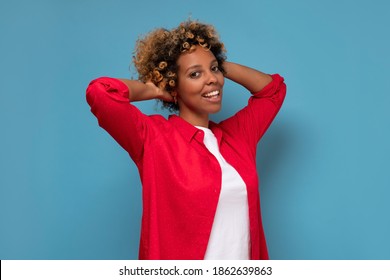 African Young Woman With Shaggy Hairstyle Smiling Cheerfully, Feeling Happy And Carefree. Studio Shot.