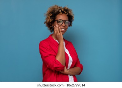 African Young Woman With Shaggy Hairstyle Smiling Cheerfully, Feeling Happy And Carefree. Studio Shot.