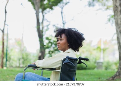 African-American Alone In A Wheelchair Enjoying On Summer Morning. Happy African American Woman With Disabilities Having A Great Time At A City Park.