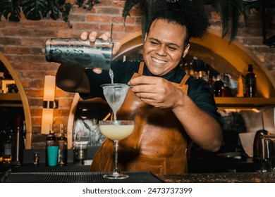 African-American bartender preparing cocktails at the bar, at an afrobeats event. Nightlife, partying and bartending. Style. - Powered by Shutterstock