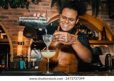 Similar – Image, Stock Photo Stylish black bartender preparing a cocktail with a smoke bubble in a traditional cocktail bar