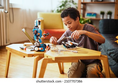 An African-American boy making a robot at home. Education in robotic at home. - Powered by Shutterstock