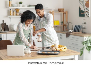 African-American brother and sister making cookies in kitchen - Powered by Shutterstock